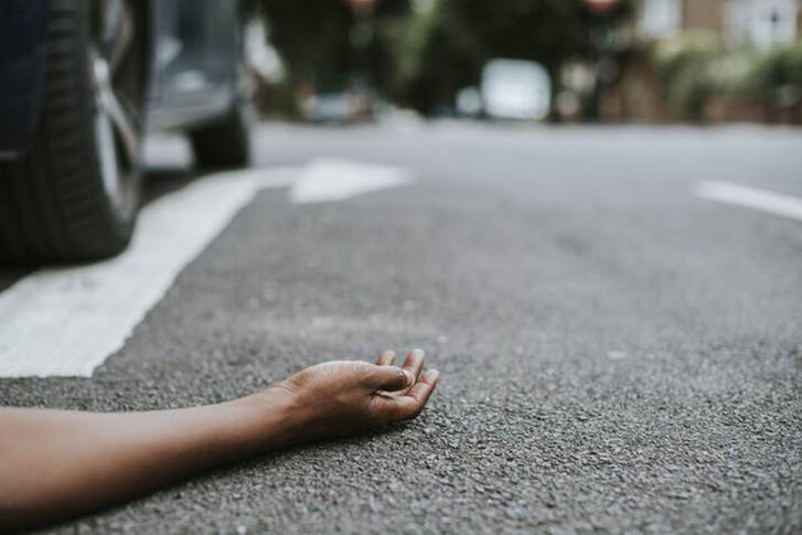 A man lying down on the road